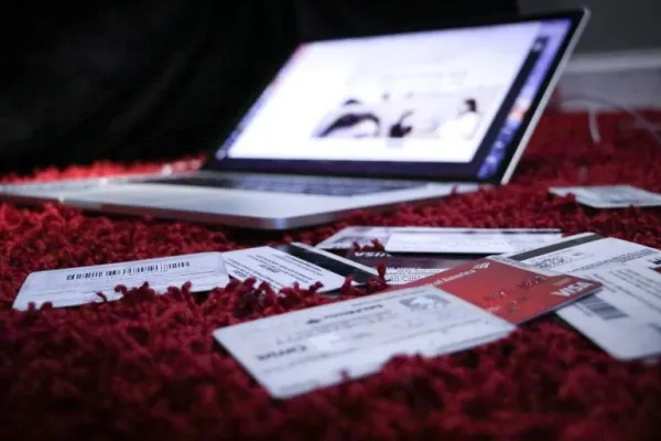laptop surrounded with multiple creditcards